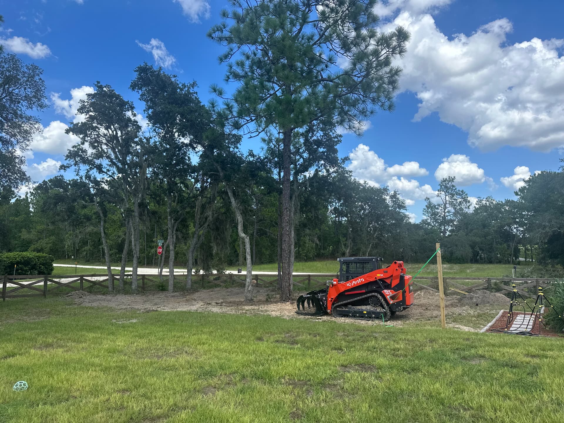 Gibson Development Group Kubota SVL75-3 compact track loader moving dirt on a Marion County Florida job site